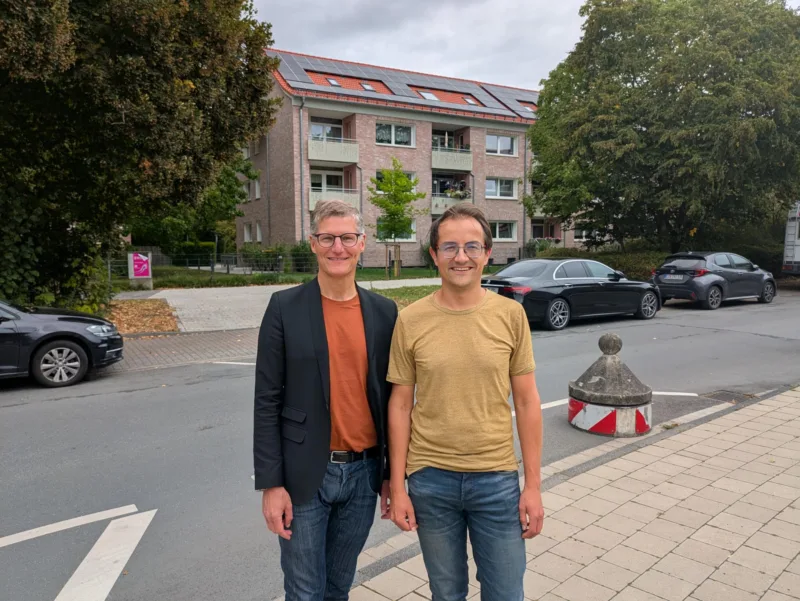 Tilman Fuchs und Robin Korte vor den neuen Photovoltaik-Anlagen auf den Dächern von Wohn+Stadtbau Gebäuden in der Aaseestadt